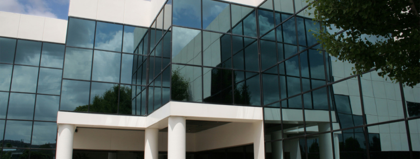 close up of office building exterior with wall to wall windows